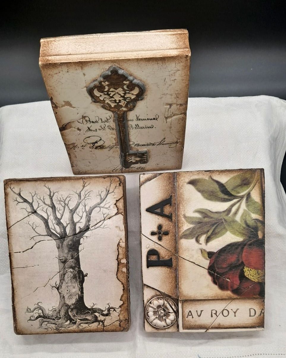 Three Sid Dickens Memory Blocks featuring a vintage key, winter tree, and botanical still life
